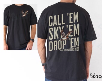 May include: Black t-shirt with a duck graphic on the front and back. The back of the shirt features the text "CALL 'EM SKY 'EM DROP 'EM" with a duck illustration and the phrase "DUCK HUNTING BE BACK NEVER!"