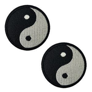 May include: Two embroidered Yin and Yang symbol patches. Each patch is round with a black border and a black and grey Yin Yang design. The patches are set against a white background.