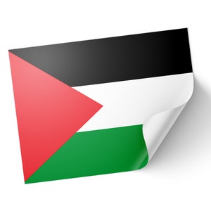 May include: A glossy sticker or print of the Palestinian flag, featuring a red triangle, black, white, and green horizontal stripes. The corner is peeled back, casting a shadow.