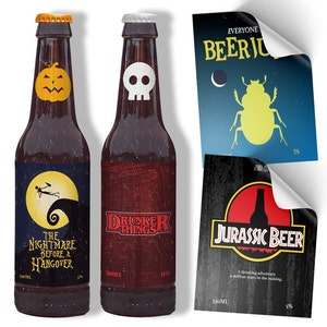 May include: Two brown beer bottles with Halloween-themed labels. One features a jack-o'-lantern and the text "The Nightmare Before a Hangover." The other has a skull and "Drunker Things." Two additional beer label designs are also visible.