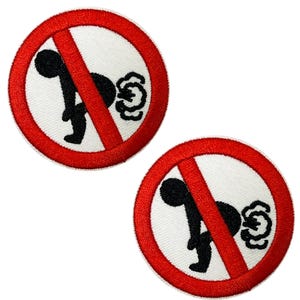 May include: Two embroidered patches with a white background and a red border. Each patch features a black figure bent over with a cloud of gas, crossed out with a red diagonal line, humorously depicting a "no farting" symbol.