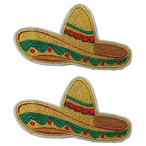 May include: Two embroidered patches of a sombrero hat. The hats are primarily gold with green and red decorative bands. The patches have a white border.