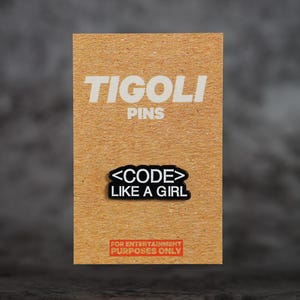 May include: A brown card with the white text "TIGOLI PINS" at the top. Below is a black and white pin that says "<CODE> LIKE A GIRL". At the bottom is a red rectangle with the text "FOR ENTERTAINMENT PURPOSES ONLY".