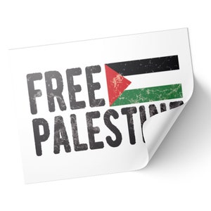 May include: White sticker with the words "FREE PALESTINE" in distressed black font. The Palestinian flag is displayed on the right side of the sticker, featuring black, white, green, and red colors.