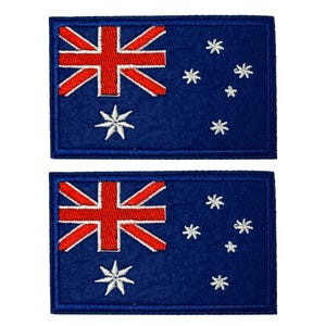 May include: Two rectangular patches displaying the Australian flag. The design features a red Union Jack in the top left, a large white seven-pointed star, and smaller white stars on a blue field. Each patch has a blue border.