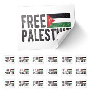 May include: White sticker with the words "FREE PALESTINE" in distressed black font. The Palestinian flag is displayed on the right side. Additional smaller stickers with the same design are below.