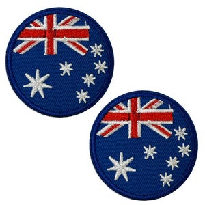 May include: Two circular, blue embroidered patches displaying the Australian flag. The design includes the Union Jack, a red cross, and white stars representing the Southern Cross constellation.