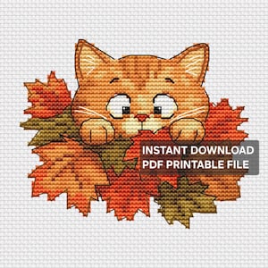 May include: A cross-stitch pattern featuring an orange tabby cat peeking out from behind a pile of autumn maple leaves in shades of red, orange, and brown. The design includes the text INSTANT DOWNLOAD PDF PRINTABLE FILE on a grey rectangle.
