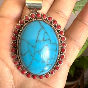 Stunning and hand carved auspicious floral symbol Tibetan crackle Turquoise pendant inlay with Coral set in Tibetan silver 2.5”in & 27grams