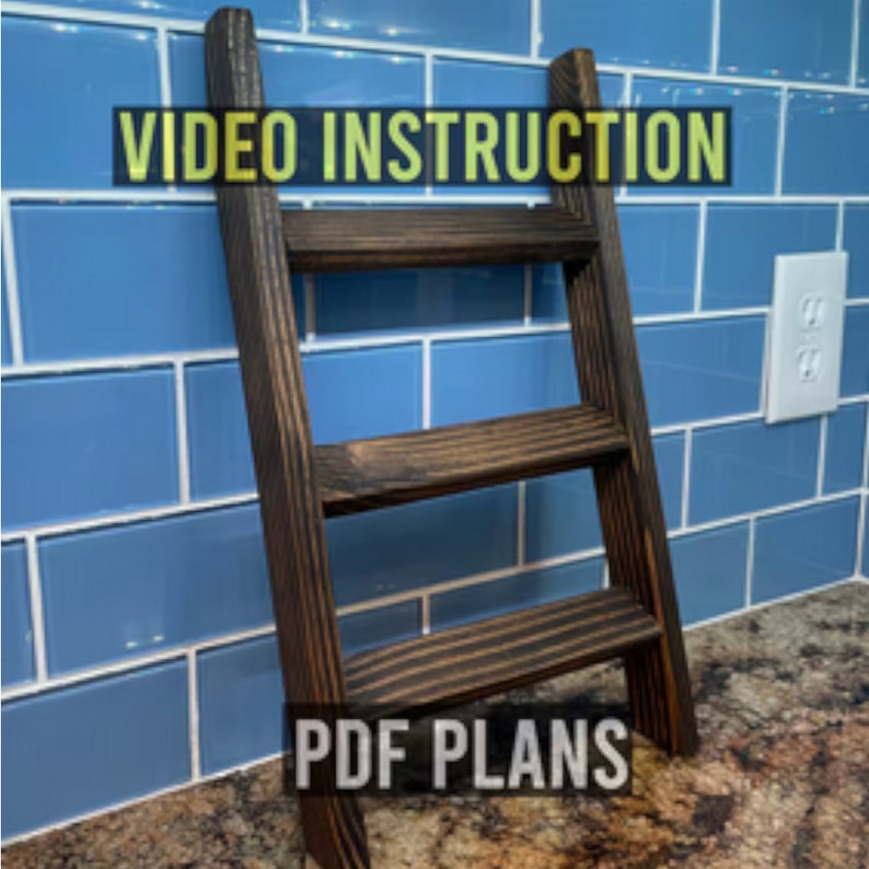 May include: A dark brown wooden ladder shelf with three shelves. The shelf is against a blue tiled wall. The text "VIDEO INSTRUCTION" is at the top of the image and the text "PDF PLANS" is at the bottom of the image.