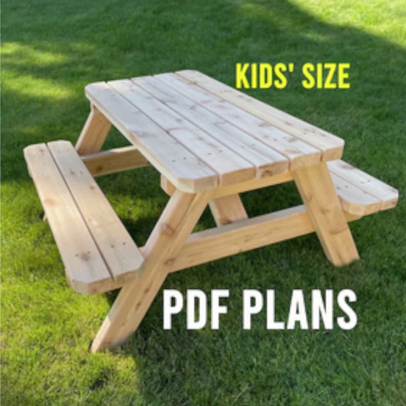 May include: A wooden picnic table designed for kids, with a natural wood finish. The table is shown on a grassy lawn. The text "KIDS' SIZE" and "PDF PLANS" is visible in the image.