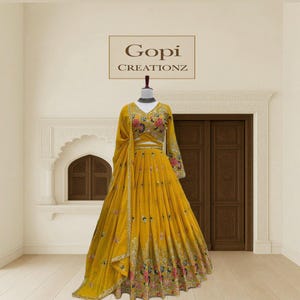 May include: A vibrant yellow formal dress with floral embroidery. The dress features a V-neckline, long sleeves, and a flowing skirt. The text "Gopi Creationz" is displayed above the dress.