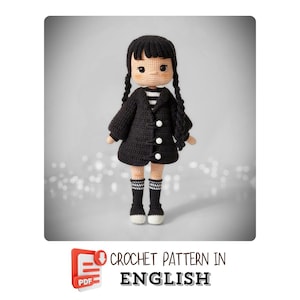 May include: A crocheted doll in a black coat with white buttons, black socks, and pigtails. The doll has a striped shirt and black shoes. The text "CROCHET PATTERN IN ENGLISH" is at the bottom.