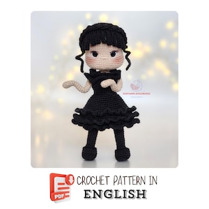 May include: A handmade crochet doll in a black dress with a ruffled skirt and a black hairstyle. The doll has a light skin tone and rosy cheeks. The image includes the text "CROCHET PATTERN IN ENGLISH".