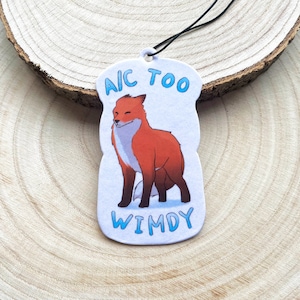 May include: White car air freshener with a red fox illustration and the text "A/C TOO WINDY".