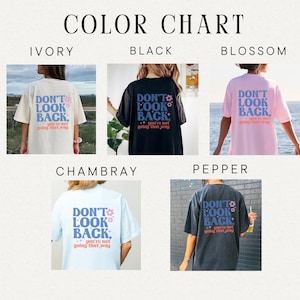 May include: Color chart showing different t-shirt colors with the text "Don't Look Back, you're not going that way" printed on the back. The colors shown are ivory, black, blossom, Chambray, and pepper.