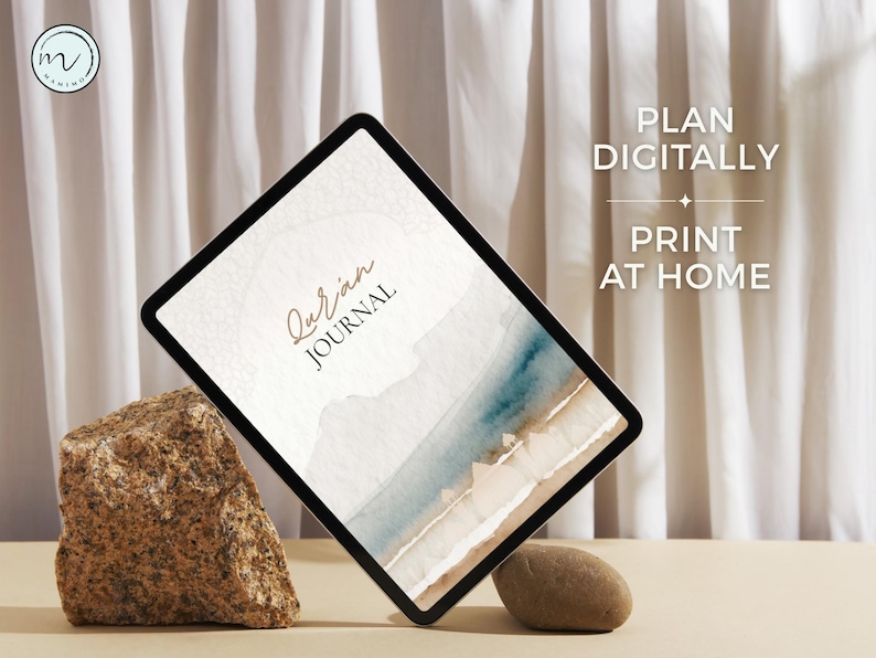 May include: A digital tablet displaying a Quran Journal cover with a watercolor landscape of blue water and sandy shores. The screen features the text Quran Journal. To the right, the text reads PLAN DIGITALLY PRINT AT HOME with a small star icon.