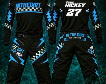 May include: A black motocross race kit featuring blue lightning bolts and checkered patterns. The jersey displays "INTHEDIRT" and "ROCZEN HICKEY 27". The trousers feature "THE DIRT STAY FAST" and "IN THE DIRT CLOTHING CO." text. The kit is labelled 2026 RACE KIT.