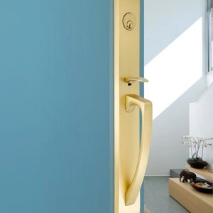 May include: A gold door handle with a lever and a keyhole. The handle is mounted on a blue door.