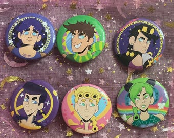 May include: Six colorful round buttons featuring anime-style character illustrations. The buttons have various background colors, including purple, green, pink, and blue, with detailed character portraits. The buttons are likely for fans of the anime series.
