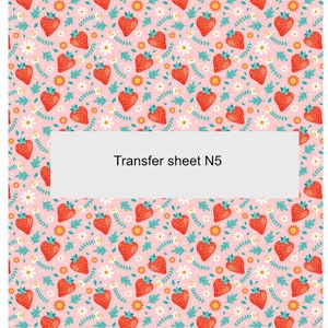 May include: A pink transfer sheet with a repeating pattern of red strawberries, white daisies, and green leaves. The text "Transfer sheet N5" is printed in the center of the sheet.