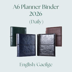 May include: Four A6 planner binders in green, navy, black, and brown leather. Each binder has an elastic closure. The text on the image reads "A6 Planner Binder 2026 (Daily)" and "English/Gaeilge".