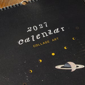 2027 Wall Calendar Surreal Art Space Theme Celestial Imagery Moon Planets Vintage Collage Black Background Gold Border Spiral Bound Monthly Planner Home Office Organization Perfect Gift Artistic Wall Display Planning Essential Unique Home
