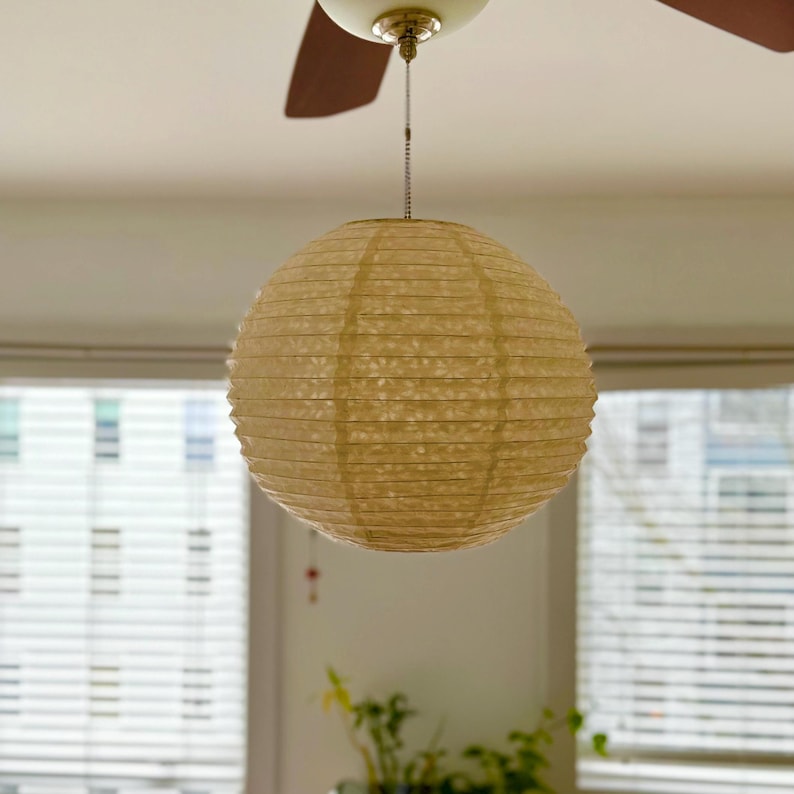 Handmade Lokta paper orb pendant lamp shade with bamboo frame – eco-friendly Japanese-style lighting. Orb-shaped Lokta paper pendant lamp in small size – sustainable minimalist decor. Neutral tone paper pendant light – perfect for Japandi and zen-inspired interiors. Set of handmade paper lamp shades in assorted sizes – minimalist home decor. Handmade Nepalese Lokta Paper Lamp Shade with Bamboo Frame - Sustainable, Durable, Lightweight. Embossed Petals, Leaves.