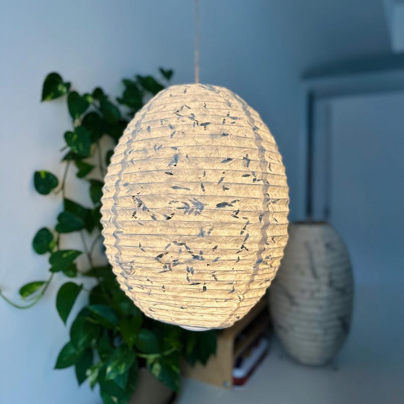 Handmade Lokta paper lamp shade with bamboo frame – eco-friendly Japanese-style lighting. Pendant Pressed with Leaves variation paper lantern – Asian-inspired handcrafted light. Hanging Handmade Nepalese Lokta Paper Lamp Shade with Bamboo Frame - Sustainable, Durable, Lightweight. Minimalist Asian-Inspired Design. Embossed Leaves. Perfect for Home Décor. Unique Shapes: Cylindrical, Abstract, Accordion Hexagon, Globe.