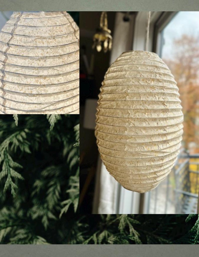 Handmade Lokta paper lamp shade with gold motifs and bamboo frame – eco-friendly Japanese-style lighting. Cylindric Pendant in Small variation paper lantern – Asian-inspired handcrafted light. Hanging Handmade Nepalese Lokta Paper Lamp Shade with Bamboo Frame - Sustainable, Durable, Lightweight. Minimalist Asian-Inspired Design. Embossed Petals. Gold Motifs. Perfect for Home Décor. Unique Shapes: Cylindrical, Abstract, Accordion Hexagon, Globe.
