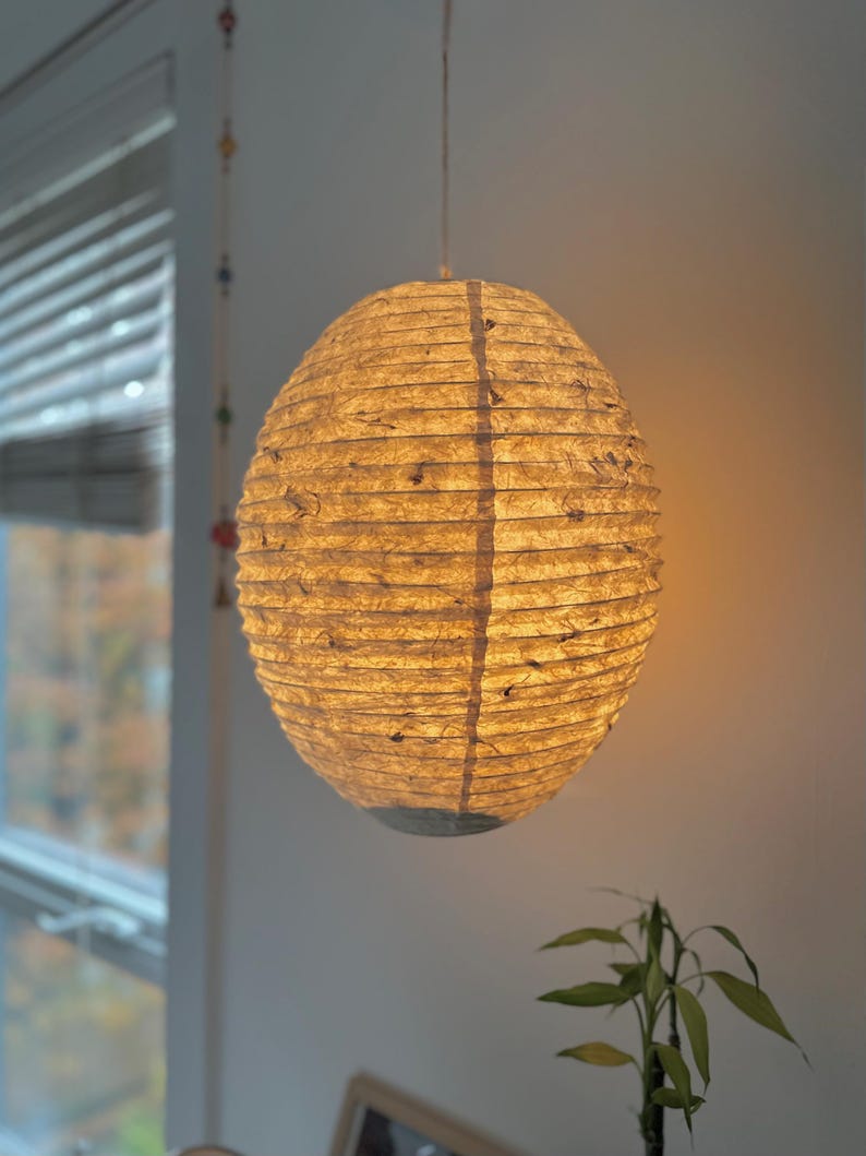 Handmade Lokta paper lamp shade with bamboo frame – eco-friendly Japanese-style lighting. Pendant Pressed with Petals variation paper lantern – Asian-inspired handcrafted light. Hanging Handmade Nepalese Lokta Paper Lamp Shade with Bamboo Frame - Sustainable, Durable, Lightweight. Minimalist Asian-Inspired Design. Embossed Petals. Perfect for Home Décor. Unique Shapes: Cylindrical, Abstract, Accordion Hexagon, Globe.