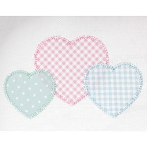 May include: Three heart-shaped appliqués in pastel colors on a white background. The largest heart is pink gingham, the smallest is light blue with white polka dots, and the third is blue gingham. All have stitched edges.