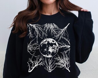 Peut inclure: Sweat-shirt noir avec un motif blanc d'une pleine lune entourée de branches.