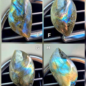 May include: Four polished labradorite gemstones, each displaying iridescent flashes of blue, green, and gold. The stones have a teardrop shape and are set against a dark background, highlighting their vibrant colors and natural patterns. These gemstones are ideal for jewelry making.