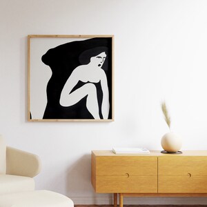 May include: A black and white framed illustration of a woman sitting with her legs crossed, with a black background and white outline.