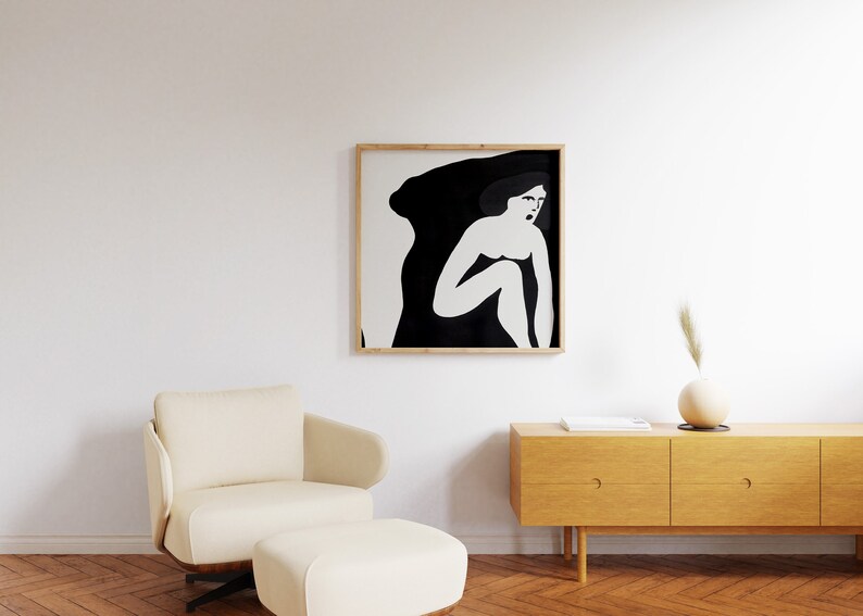 May include: A black and white framed illustration of a woman sitting with her legs crossed, with a black background and white outline.