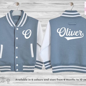 Personalised kids varsity jacket with custom print featuring initial on the front and name on the back. The jacket is made of high quality materials and has contrasting sleeves, striped rib knit cuffs and a snap button closure