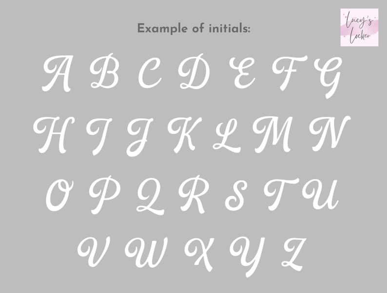 May include: A gray chart displaying the full alphabet in white, cursive, uppercase letters arranged in four rows. The text 'Example of initials:' is centered at the top, and a small logo for 'Lucy's Locker' is positioned in the top right corner.