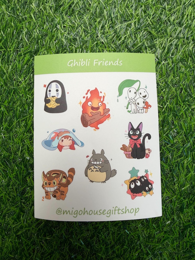 Może przedstawiać: Arkusz naklejek z r&oacute;żnymi postaciami z film&oacute;w studia Ghibli. Naklejki zawierają postacie takie jak No-Face, Calcifer i Totoro. Tekst "Ghibli Friends" znajduje się na g&oacute;rze, a nazwa użytkownika Instagram sklepu na dole.