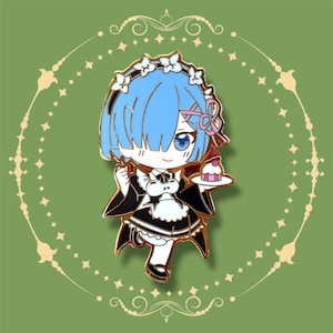 May include: Enamel pin featuring a cartoon character with blue hair, wearing a maid outfit and holding a small cake on a plate. The pin has gold-colored outlines and is set against a green background with decorative elements.