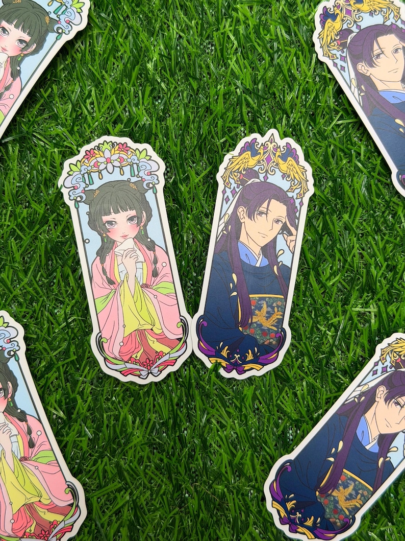 May include: Several stickers featuring anime-style illustrations of characters in traditional Asian attire. The stickers have a rectangular shape with ornate decorative borders. The characters are depicted with detailed facial features and colorful clothing.