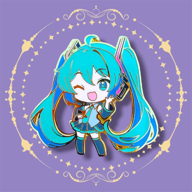 May include: A teal and gold enamel pin featuring a cartoon character with teal hair and a matching outfit. The character is winking and waving, set against a purple background with gold decorative elements. The pin has a gold outline.