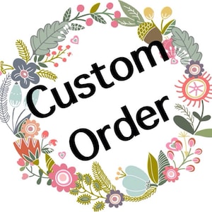 May include: A floral wreath with the text "Custom Order" in black lettering.