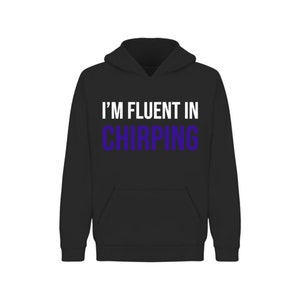 May include: Black hooded sweatshirt with the text "I'M FLUENT IN CHIRPING" in white and purple.