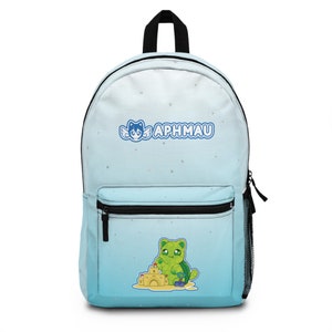 May include: A blue and white ombre backpack with a white cat with wings and the text "Aphmau" on the front. The backpack has a green cat with a sandcastle on the bottom.