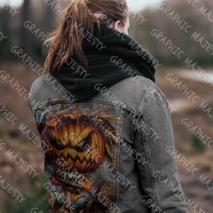 May include: A gray denim jacket with a black hoodie underneath. The back of the jacket features a graphic of a pumpkin with a scary face and the text "Go Away!"