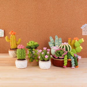 May include: A collection of crocheted cacti and succulents in various shapes and sizes. The plants feature shades of green, yellow, and pink, potted in small white crocheted containers or a larger brown crocheted basket, showcasing intricate yarn textures.