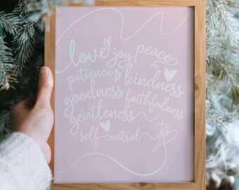 May include: A framed print with a pink background and white text. The text reads "love, joy, peace, patience, kindness, goodness, faithfulness, gentleness, self-control".