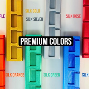 Pode incluir: Uma exibi&ccedil;&atilde;o de oito objetos impressos em 3D de cores diferentes, cada um com uma cor diferente e o texto "SILK" seguido do nome da cor. O texto "PREMIUM COLORS" est&aacute; no centro da imagem.