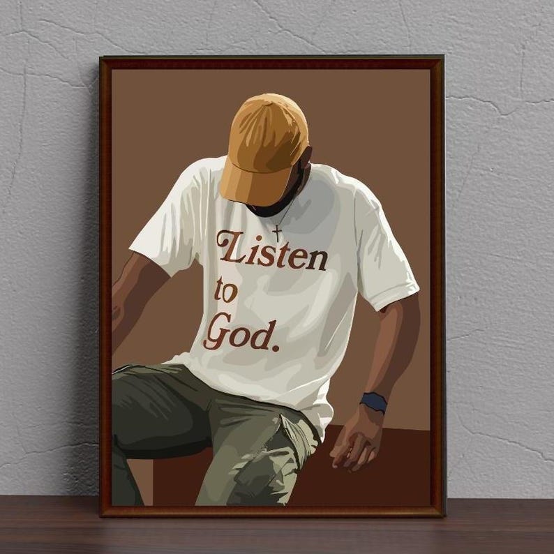 May include: A person wearing a white t-shirt with the text "Listen to God." in brown lettering. The person is wearing a brown baseball cap and khaki pants. The background is a brown color.